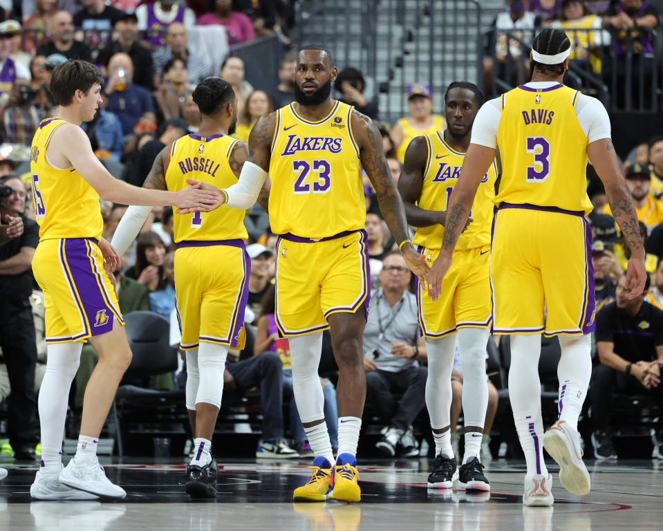 LAS VEGAS, NEVADA - OCTOBER 09: LeBron James #23 of the Los Angeles Lakers slaps hands with teammates Austin Reaves #15 and Anthony Davis #3 after James drew a foul against the Brooklyn Nets in the first quarter of their preseason game at T-Mobile Arena on October 09, 2023 in Las Vegas, Nevada. The Lakers defeated the Nets 129-126. NOTE TO USER: User expressly acknowledges and agrees that, by downloading and or using this photograph, User is consenting to the terms and conditions of the Getty Images License Agreement. (Photo by Ethan Miller/Getty Images)