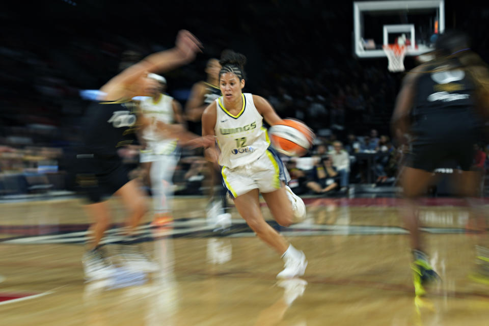 Dallas Wings guard Veronica Burton (12) drives against the Las Vegas Aces during the second half in Game 2 of a WNBA basketball semifinal series Tuesday, Sept. 26, 2023, in Las Vegas. (AP Photo/John Locher)
