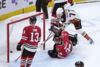 Anaheim Ducks' Frank Vatrano scores the game winning goal past Chicago Blackhawks goaltender Petr Mrazek (34) as Max Domi watches during the overtime period of an NHL hockey game Tuesday, Feb. 7, 2023, in Chicago. The Ducks won 3-2. (AP Photo/Charles Rex Arbogast)