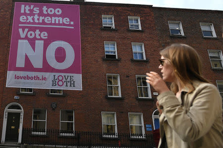 A woman looks at a pro-life poster draped over buildings encouraging people to vote 'No' ahead of a 25th May referendum on abortion law, in Dublin, Ireland May 22, 2018. REUTERS/Clodagh Kilcoyne