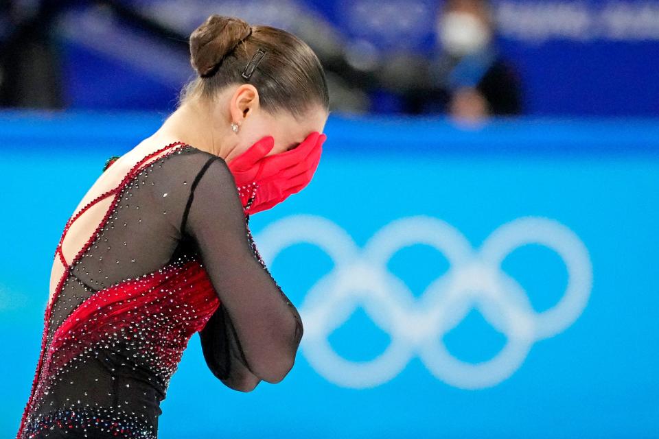 Kamila Valieva (ROC) puts her hands over her face after finishing fourth in the women’s figure skating free program during the Beijing 2022 Olympic Winter Games.