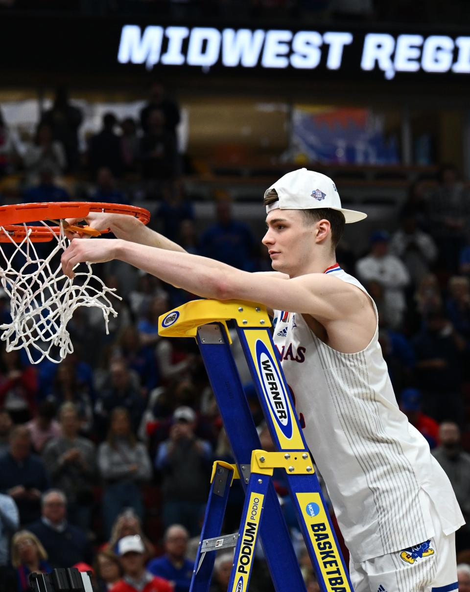 Kansas guard Christian Braun cuts down part of the net on March 27 in Chicago, after the Jayhawks topped Miami to advance to the Final Four. Braun helped lead the Jayhawks to the national title.