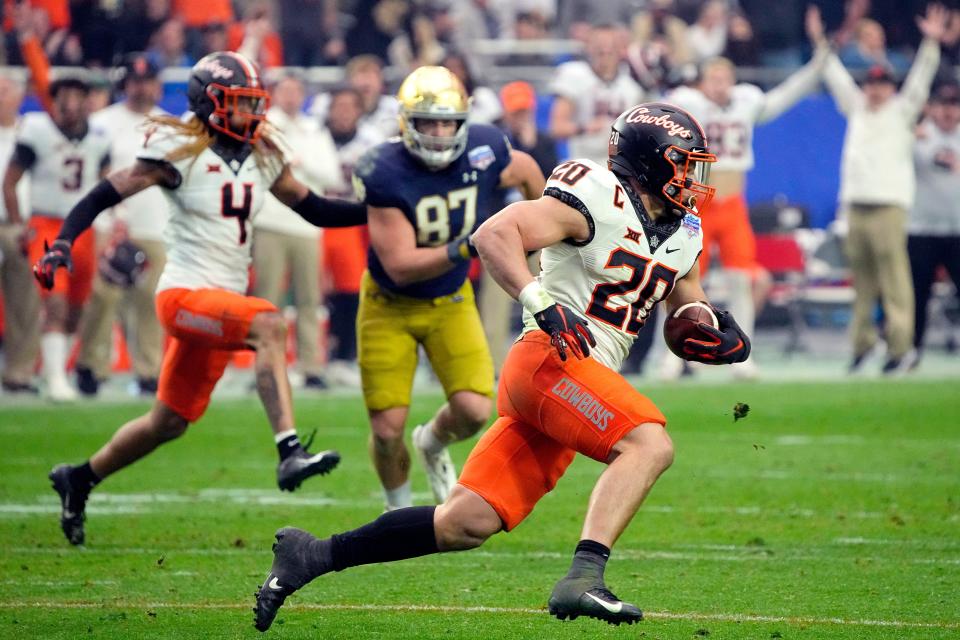 OSU linebacker Malcolm Rodriguez intercepts a pass against Notre Dame in the Fiesta Bowl last January. Could OSU and Notre Dame soon be NBC partners? RICK SCUTERI/Associated Press