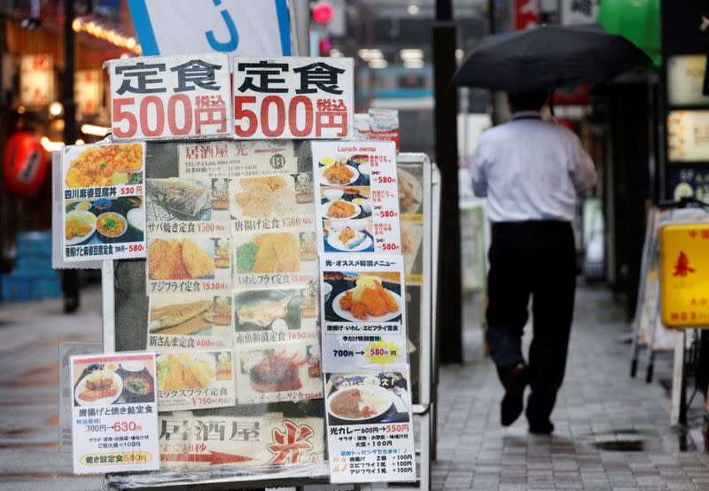 An advertisement board of a restaurant is seen at a business district in Tokyo