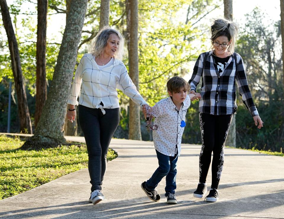 Tiffany Clark with her son, Kylhar, 7, and mother, Donna Koenig in Daytona Beach.