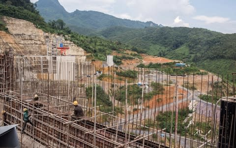 Workers prepare reinforcing steel at the Nam Tha 1 hydroelectric dam construction site - Credit: Bloomberg/Taylor Weidman