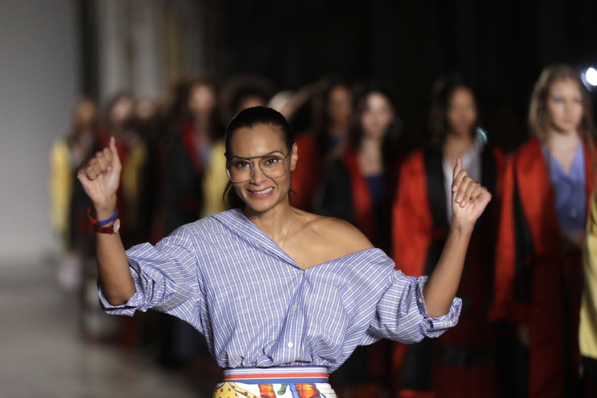 Designer Stella Jean accepts applause at the end of her womens Spring/Summer 2018/19 fashion collection, presented in Milan, Italy, on Sept. 24, 2017. (AP Photo/Luca Bruno, File)