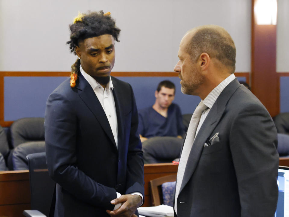 Former NFL cornerback Damon Arnette leaves the courtroom with his attorney Ross Goodman following his arraignment at the Regional Justice Center, Wednesday, May 24, 2023, in Las Vegas. Arnette pleaded not guilty to felony charges alleging that he brandished a handgun during an argument with Las Vegas Strip casino valets in January 2022, and his lawyer is challenging his indictment. (Bizuayehu Tesfaye/Las Vegas Review-Journal via AP)