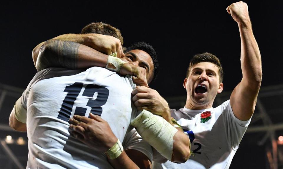Henry Slade celebrates with Manu Tuilagi and Ben Youngs after scoring England’s third try