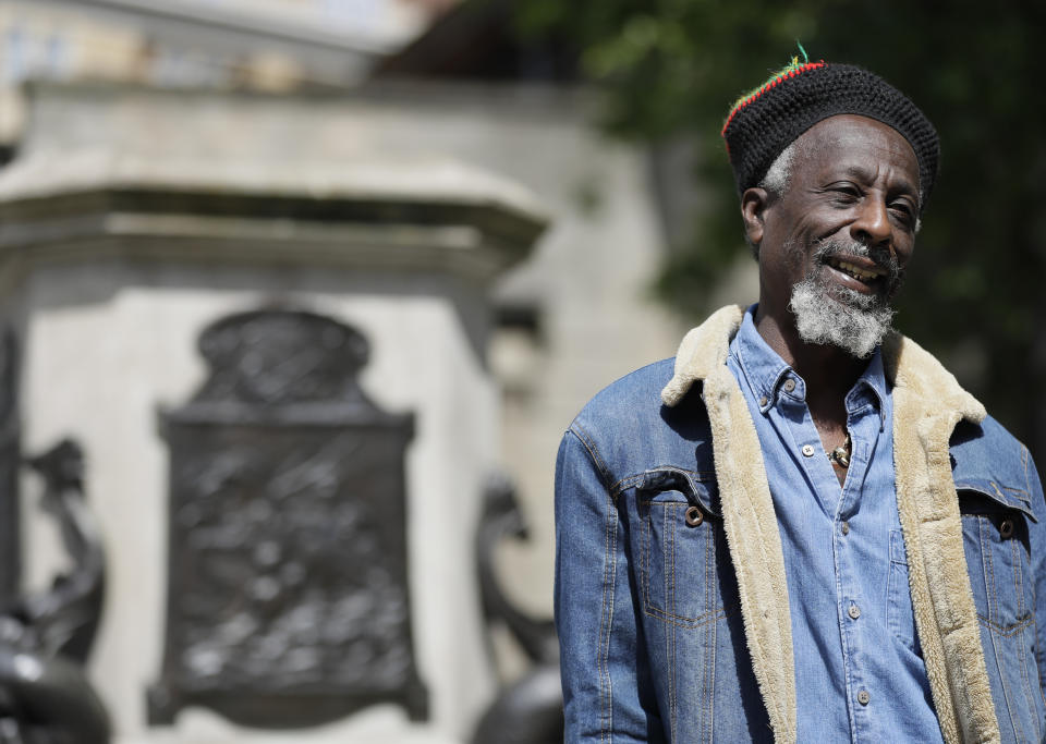 Simbarashe Tongogara speaks to the Associated Press in front of the pedestal of the toppled statue of Edward Colston in Bristol, England, Monday, June 8, 2020. The toppling of the statue was greeted with joyous scenes, recognition of the fact that he was a notorious slave trader — a badge of shame in what is one of Britain’s most liberal cities. (AP Photo/Kirsty Wigglesworth)