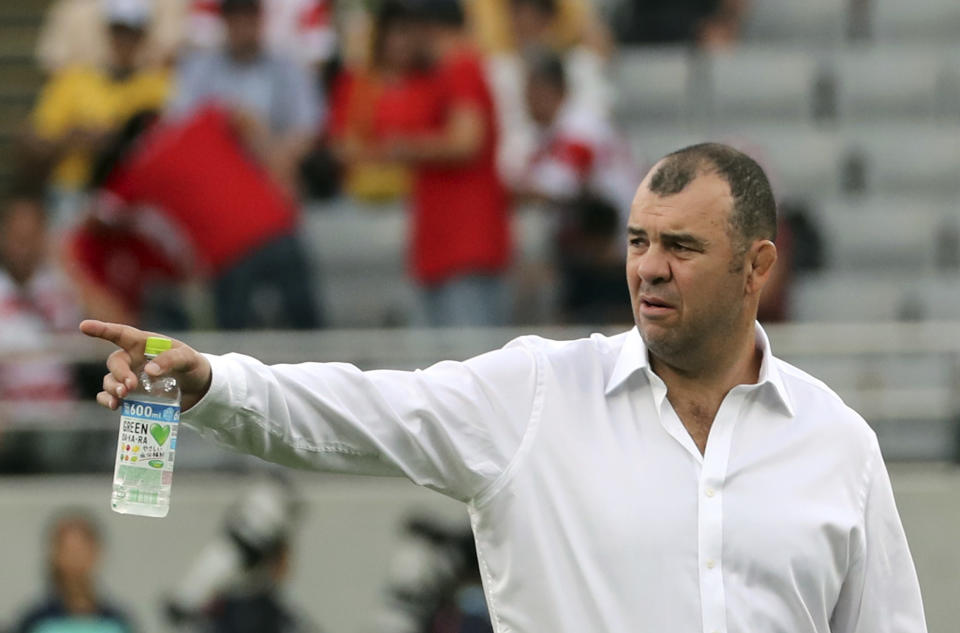 Australia's coach Michael Cheika gestures as his players warm up ahead of the Rugby World Cup Pool D game at Tokyo Stadium between Australia and Wales in Tokyo, Japan, Sunday, Sept. 29, 2019. (AP Photo/Koji Sasahara)