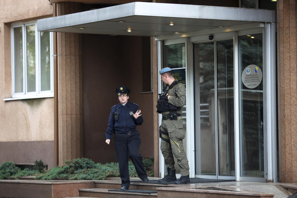 Members of the police and special police unit of Federal police stand guard in front of the headquarters of the Federal police administration during the search of those premises in Sarajevo, Bosnia, Monday, April 22, 2024.In a large-scale raid conducted in Bosnia and Herzegovina, law enforcement officers swarmed homes and offices of 23 persons suspected to be part of the 'inner circle' of a drug kingpin. (AP Photo/Armin Durgut)