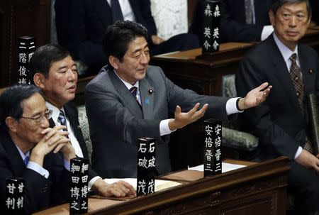 Then incoming Japanese Prime Minister and leader of the Liberal Democratic Party (LDP) Shinzo Abe (2nd R) gestures as he takes his seat at the Lower House of the Parliament in Tokyo, in this file picture taken December 26, 2012. REUTERS/Toru Hanai