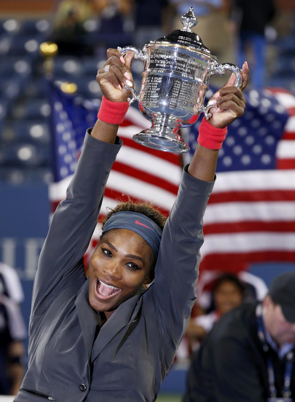 Serena Williams of the U.S. raises her trophy after defeating Azarenka of Belarus in their women's singles final match at the U.S. Open tennis championships in New York