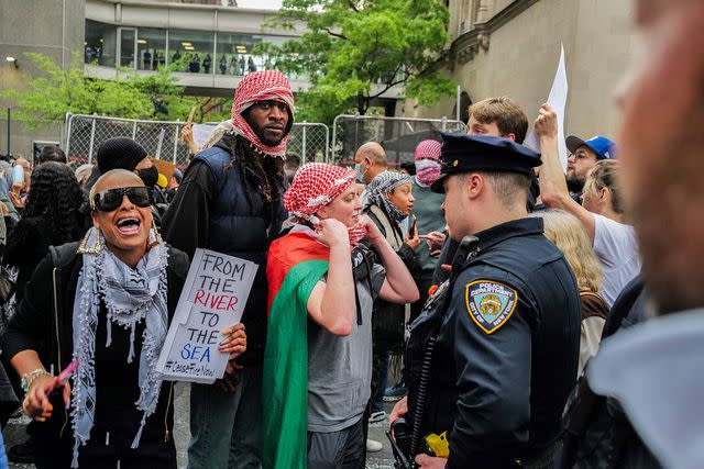 <p>CHARLY TRIBALLEAU/AFP via Getty</p> Demonstrators outside the Met Gala