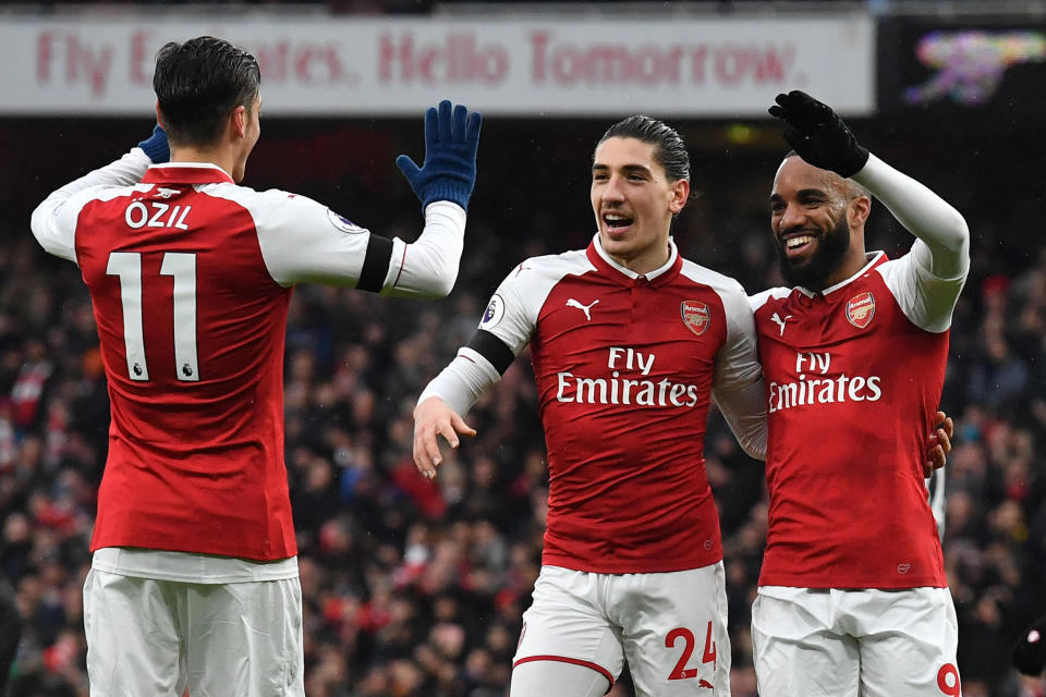 Alexandre Lacazette (R) celebrates after scoring Arsenal’s fourth goal with Spanish defender Hector Bellerin (C) and German midfielder Mesut Ozil