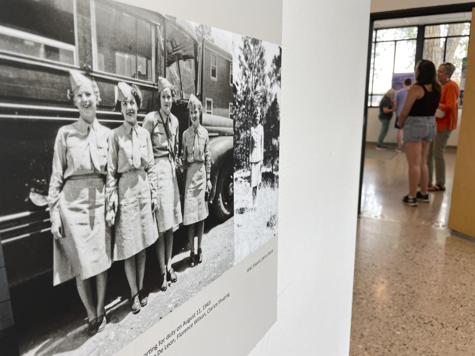 A historical display stands inside the Manhattan Project National Historical Park visitor center on Aug. 13, 2023, as tourists ask rangers questions in Los Alamos, N.M. Los Alamos was the perfect spot for the U.S. government's top-secret Manhattan Project. Almost overnight, the remote location was transformed to accommodate the scientists who developed the world's first atomic bomb. The community is facing growing pains again, 80 years later, as it works to modernize the country's nuclear arsenal. (AP Photo/Susan Montoya Bryan)