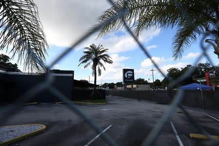 The Pulse night club sign is pictured through a fence following the mass shooting there last week in Orlando, Florida, U.S., June 21, 2016. REUTERS/Carlo Allegri