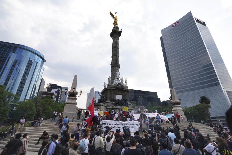 Journalists hold photos and banners mentioning murdered colleagues during a protest to draw attention to the latest wave of journalist killings, at the Angel of Independence monument in Mexico City, Monday, May 9, 2022. Two journalists Yessenia Mollinedo Falconi and Sheila Johana García Olivera, director and reporter, respectively, of the online news site El Veraz in Cosoleacaque, were shot to death in the state of Veracruz, on the Gulf of Mexico coast, on Monday. (AP Photo/Marco Ugarte)