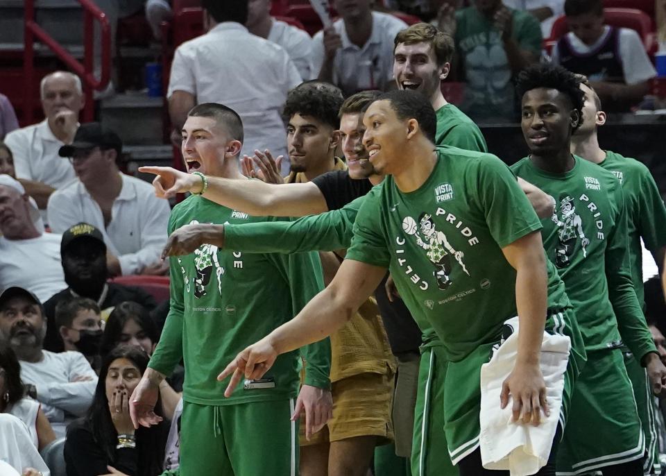 Boston Celtics players cheer the team from the bench during the second half of Game 2 of the NBA basketball Eastern Conference finals playoff series against the Miami Heat, Thursday, May 19, 2022, in Miami. (AP Photo/Lynne Sladky)