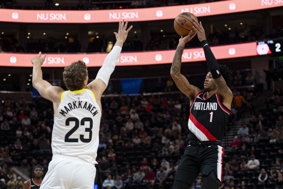 Portland Trail Blazers guard Anfernee Simons (1) shoots the ball while guarded by Utah Jazz forward Lauri Markkanen (23) during the first half of an NBA preseason basketball game Saturday, Oct. 14, 2023, in Salt Lake City. (AP Photo/Isaac Hale)