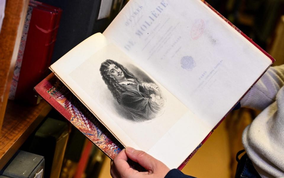 A page from an old anthology of plays by French playwright Moliere, at the Comedie Francaise library - BERTRAND GUAY /AFP 