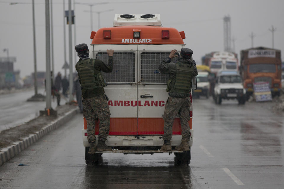 Indian paramilitary soldiers hang on to an ambulance carrying bodies of their colleagues near the site of an explosion in Pampore, Indian-controlled Kashmir, Thursday, Feb. 14, 2019. Security officials say at least 10 soldiers have been killed and 20 others wounded by a large explosion that struck a paramilitary convoy on a key highway on the outskirts of the disputed region's main city of Srinagar. (AP Photo/Dar Yasin)