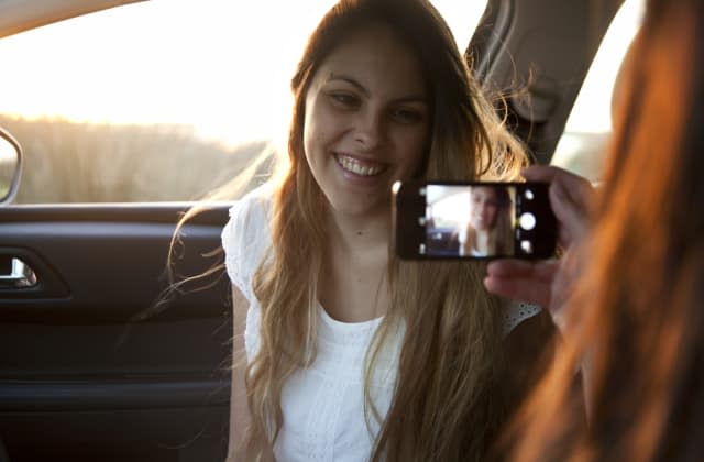 Girl taking a picture to her girl friend