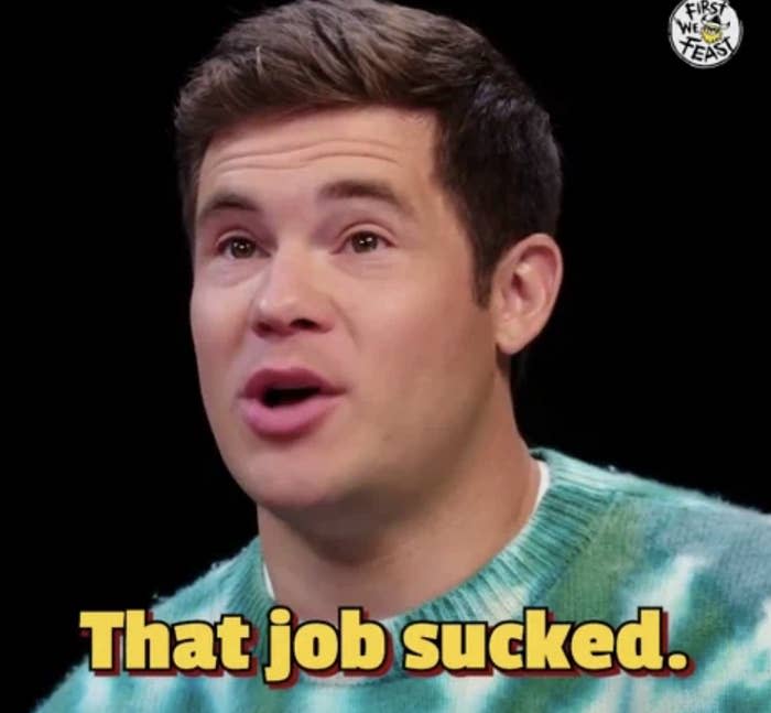 Adam Devine in a blue and white sweater, with the text "That job sucked" overlaid on the image