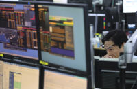 A currency trader watches monitors at the foreign exchange dealing room of the KEB Hana Bank headquarters in Seoul, South Korea, Friday, March 29, 2019. Asian markets were mostly higher on Friday as U.S. and Chinese officials kicked off a fresh round of trade talks in Beijing. (AP Photo/Ahn Young-joon)