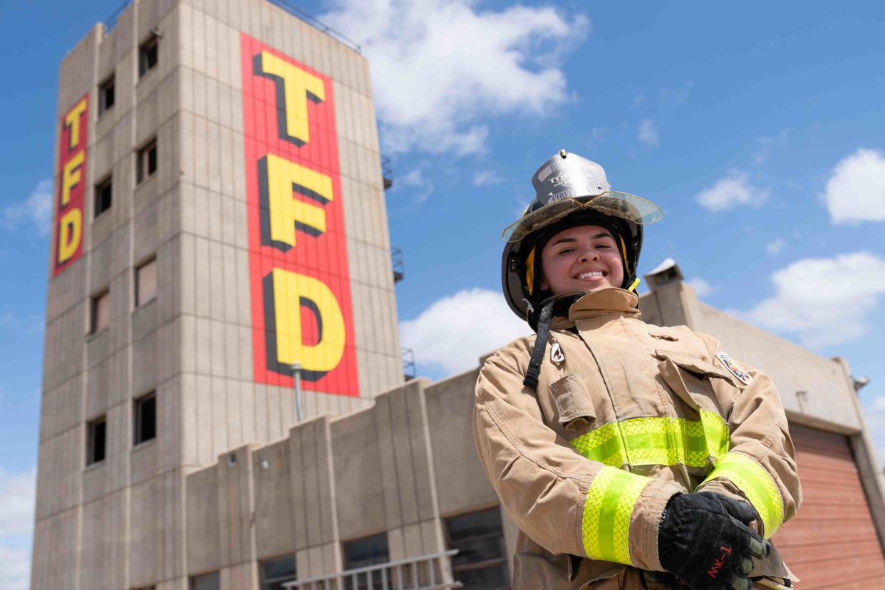 Topeka Fire Department recruit BreAnna Droge poses in front of the TFD training tower Friday afternoon at the headquarters in downtown Topeka. Droge is the first woman recruited to the fire department after attending Camp Courage.