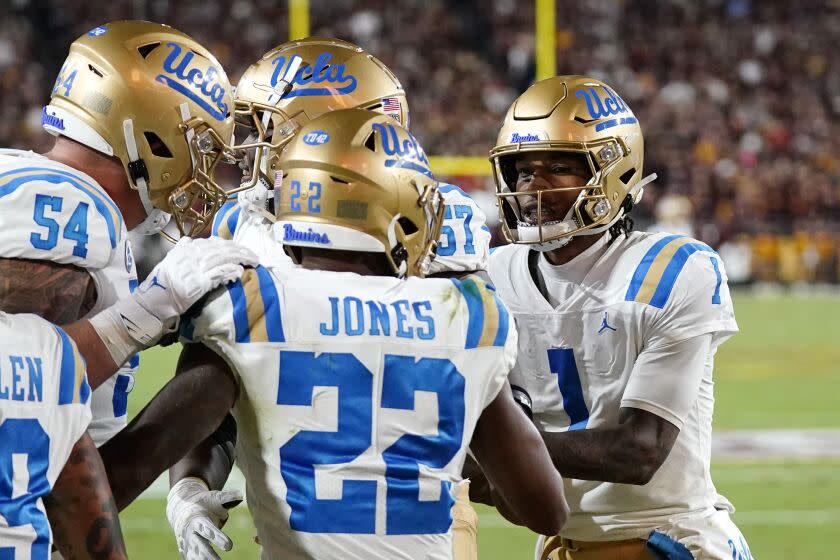 UCLA running back Keegan Jones celebrates with teammates after scoring