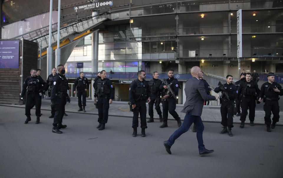 Police officers guard the Stade de France prior the Champions League final soccer match between Liverpool and Real Madrid, in Saint Denis near Paris, Saturday, May 28, 2022. (AP Photo/Christophe Ena)