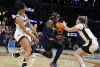 UConn forward Aaliyah Edwards (3) fights for a loose ball with Iowa forward Hannah Stuelke, left, and guard Kate Martin, right, during the first half of a Final Four college basketball game in the women's NCAA Tournament, Friday, April 5, 2024, in Cleveland. (AP Photo/Morry Gash)