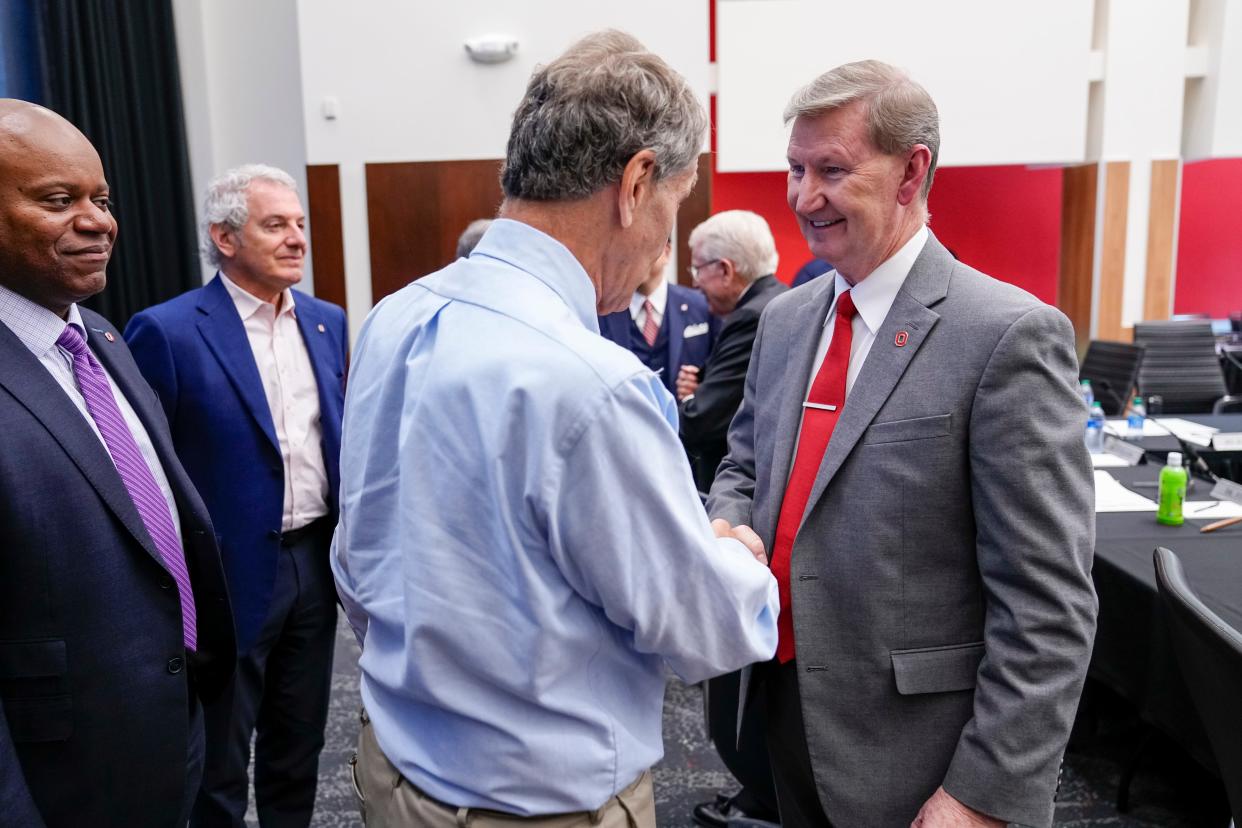 Ohio State University Trustee Jeff Kaplan congratulates Walter E. "Ted" Carter Jr. on Tuesday after the Ohio State University Board of Trustees held a special meeting to name Carter the school’s new president.