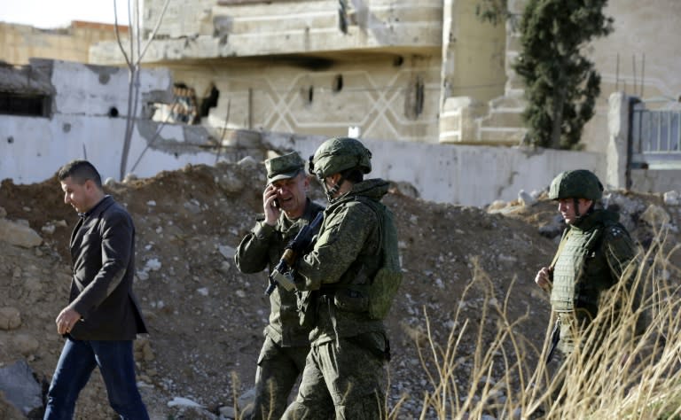 Russian army officers are seen at a newly-opened crossing in the southern tip of the rebel-held Eastern Ghouta enclave near the Syrian capital on March 8, 2018