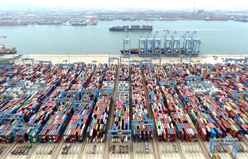 FILE PHOTO: Containers and cargo vessels at the Qingdao port