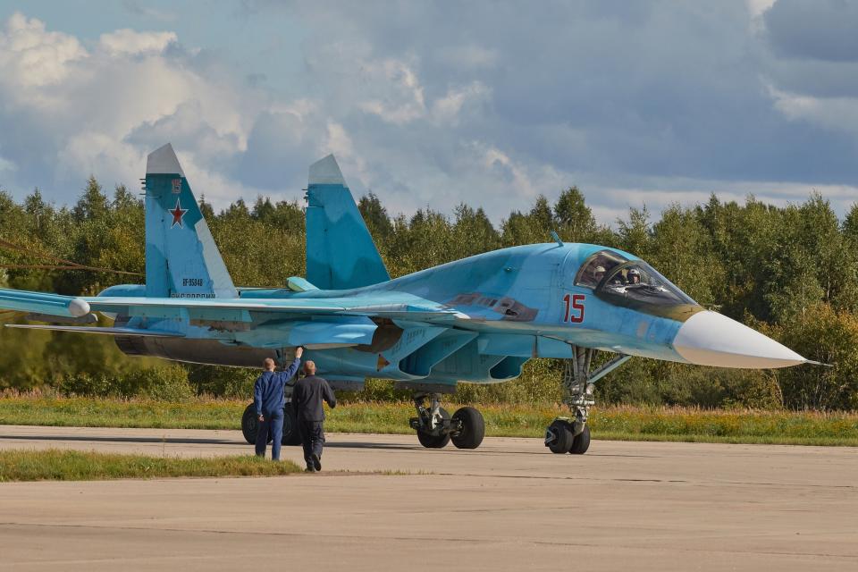 A group of technicians meets the Su-34 on the runway. Aviation show at the Kubinka airfield during the Army-2020 international forum of the Russian Ministry of Defense. (Photo by Mihail Tokmakov/SOPA Images/LightRocket via Getty Images)