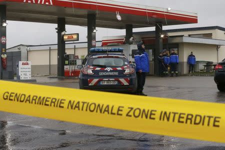 A Gendarmerie cordon is seen at a gas station in Villers-Cotterets, north-east of Paris, where armed suspects from the attack on French satirical weekly newspaper Charlie Hebdo were spotted in a car, January 8, 2015. REUTERS/Pascal Rossignol