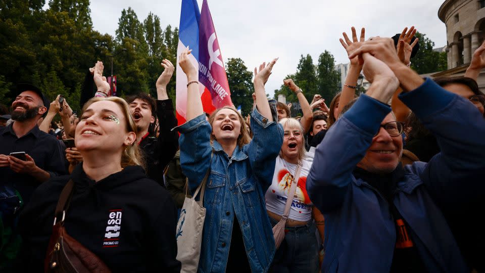 Supporters of the far-left France Unbowed party cheers the results near Stalingrad square in Paris. - Yara Nardi/Reuters