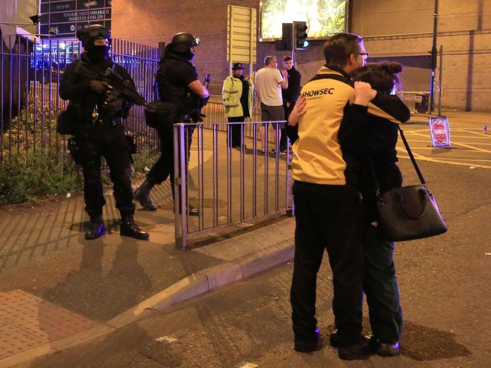 Two people hug after the Manchester Arena attack