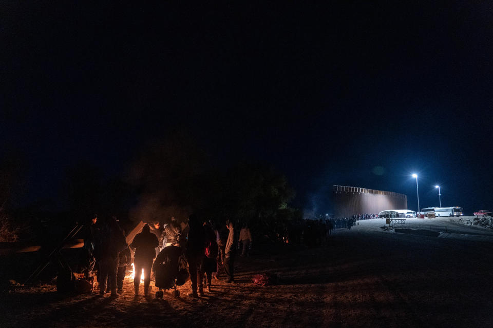 Migrants and asylum seekers are detained by U.S. Border Patrol agents after crossing the U.S.-Mexico border in Yuma County, near the Cocopah Indian Tribe's reservation on Dec. 8, 2022. Border Patrol agents estimated the group to be about 700 people.