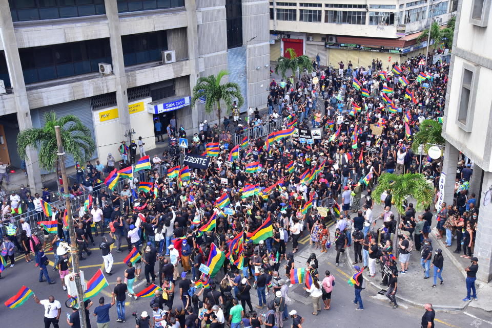 Tens of thousands of people protest in Port Louis, Mauritius, Saturday Aug. 29, 2020, over the government's slow response to an oil spill from a grounded Japanese ship and the alarming discovery of dozens of dead dolphins. (Beekash Roopun/L'express Maurice via AP)