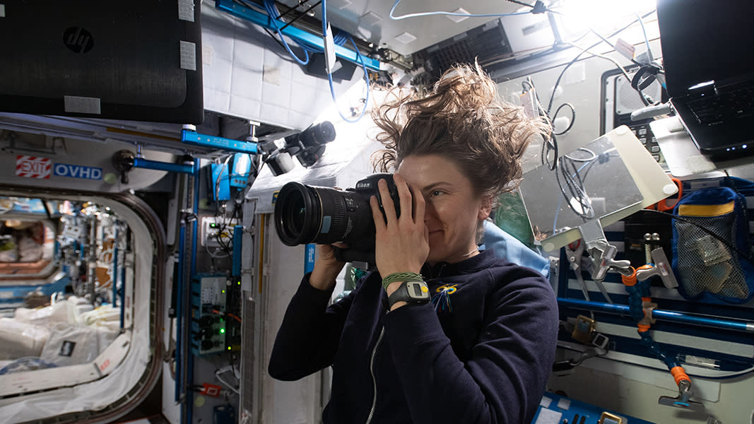   NASA astronaut and Expedition 66 flight engineer Kayla Barron takes a photograph for the SQUARE archaeology project aboard the International Space Station. 