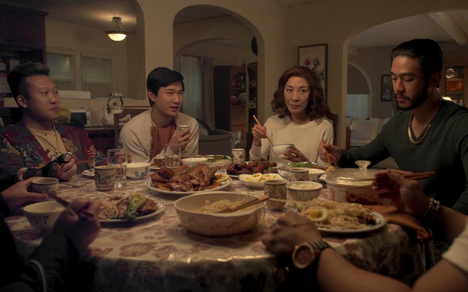 This image released by Netflix shows Joon Lee as TK, Sam Song Li as Bruce Sun, Michelle Yeoh as Mama Sun, Justin Chien as Charles Sun in an episode of "The Brothers Sun." (Netflix via AP)