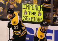 <p>Boston Bruins player Zdeno Chara (left) and Colin Miller skate past a sign put on the glass by a fan during pregame warmups. The Ottawa Senators visit the Boston Bruins in Game Three of the first round of the Stanley Cup Playoffs at TD Garden in Boston on April 17, 2017. (Photo by John Tlumacki/The Boston Globe via Getty Images) </p>