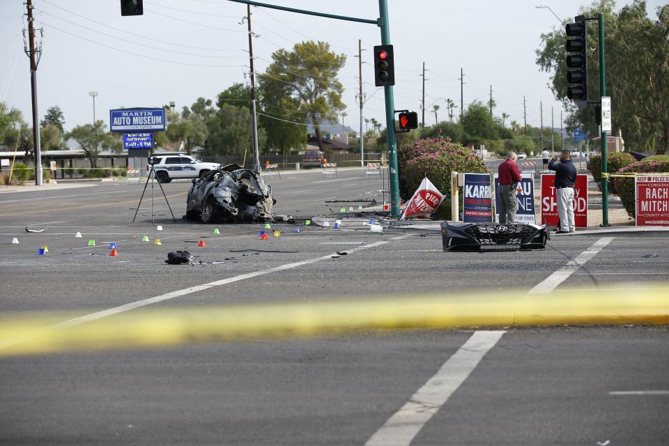 Police officers investigate the scene of an accident between North 43th Avenue and West Thunderbird Road in Phoenix on July 22, 2022.