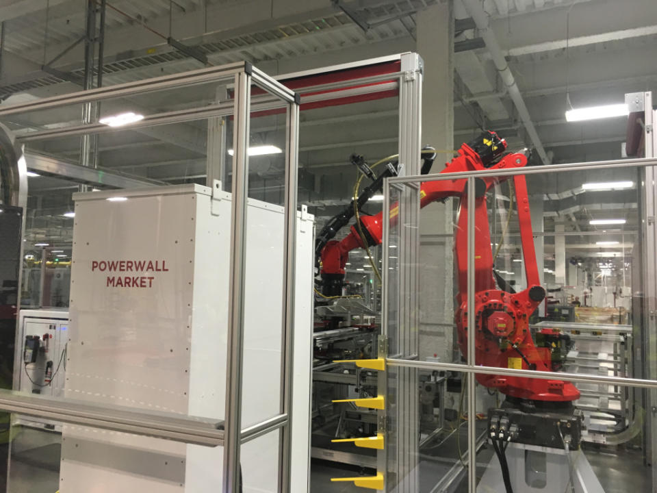 Robots assemble battery packs into Tesla's Powerwall energy storage product.