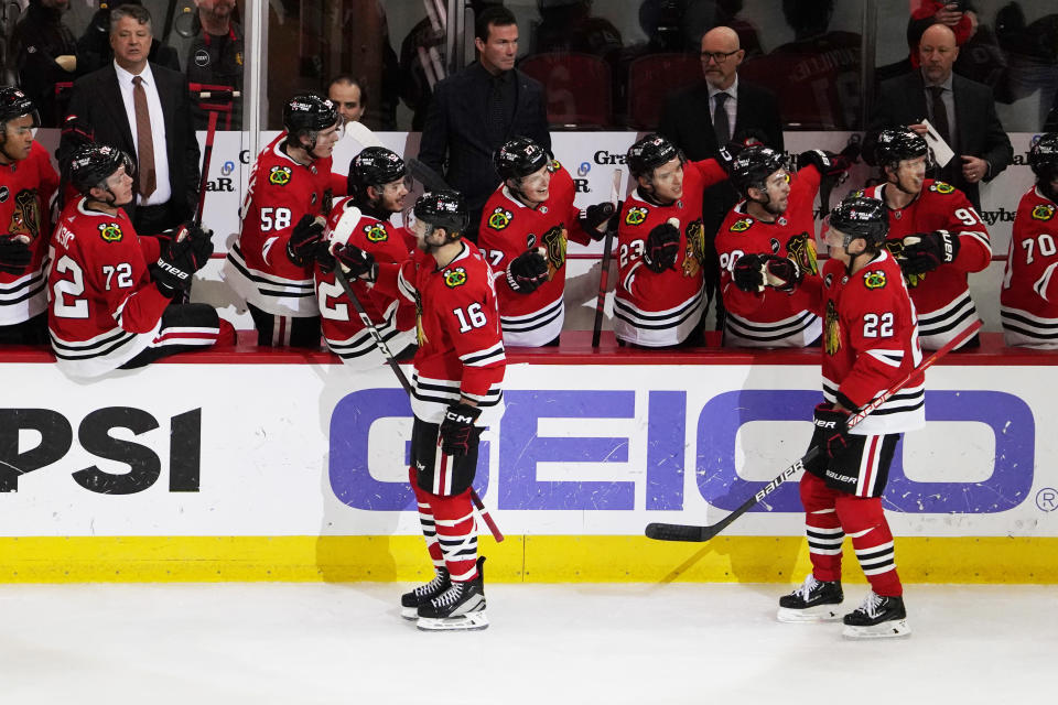 Chicago Blackhawks center Jason Dickinson (16) celebrates his goal against the St. Louis Blues with his teammates during the second period of an NHL hockey game Saturday, Dec. 9, 2023, in Chicago. (AP Photo/David Banks)