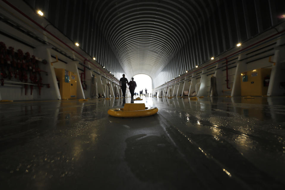 Media and social influencers tour the barge Pegasus that will transport the core stage and engines of NASA's Space Launch System (SLS) that will be used in the Artemis 1 mission, at the NASA Michoud Assembly Center in New Orleans, Monday, Dec. 9, 2019. (AP Photo/Gerald Herbert)